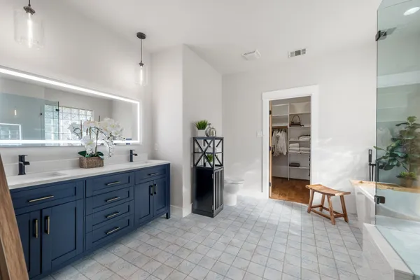a spacious bathroom with a sink and a mirror