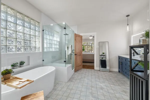 a bathroom with a bathtub and a shower