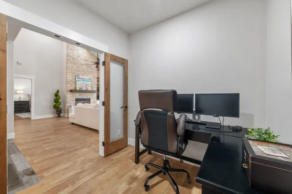 a view of a workspace with furniture and a window