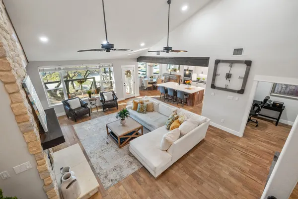 a living room with furniture and a chandelier
