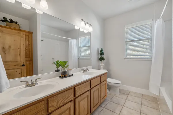 a bathroom with a double vanity sink and a mirror