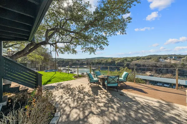 a view of a lake with a floor to ceiling window next to a yard