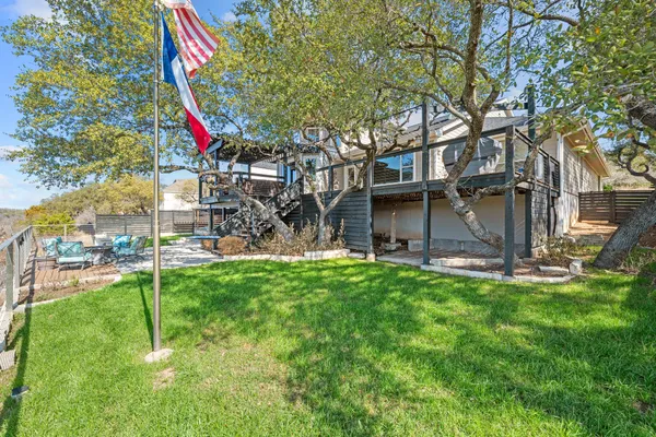 a view of a house with a yard and sitting area