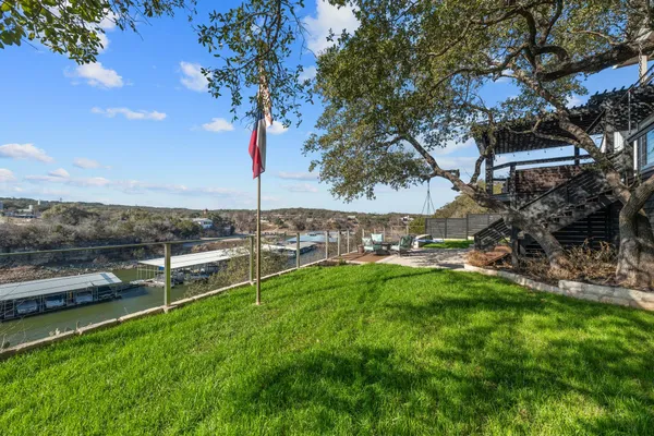 a view of a backyard with lawn chairs and a fire pit