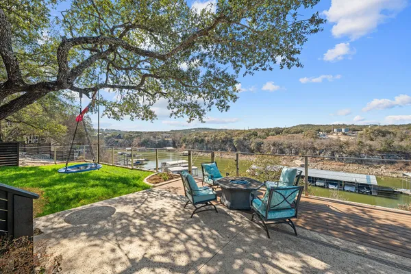 a view of a lake with couches in the patio and garden