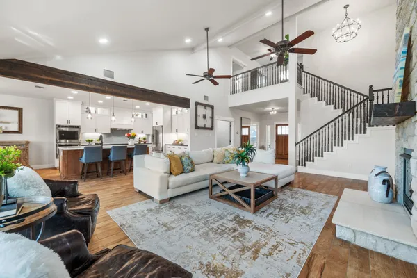 a living room with furniture and a chandelier