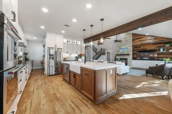 a kitchen with stainless steel appliances granite countertop a stove and a refrigerator