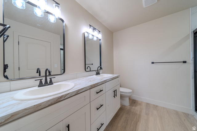 130 Pole Line Road, Unit 2 Roosevelt, UT 84066 - Photo 18 of 33 Dual vanity with undermount sinks, patterned countertop, and matte black fixtures