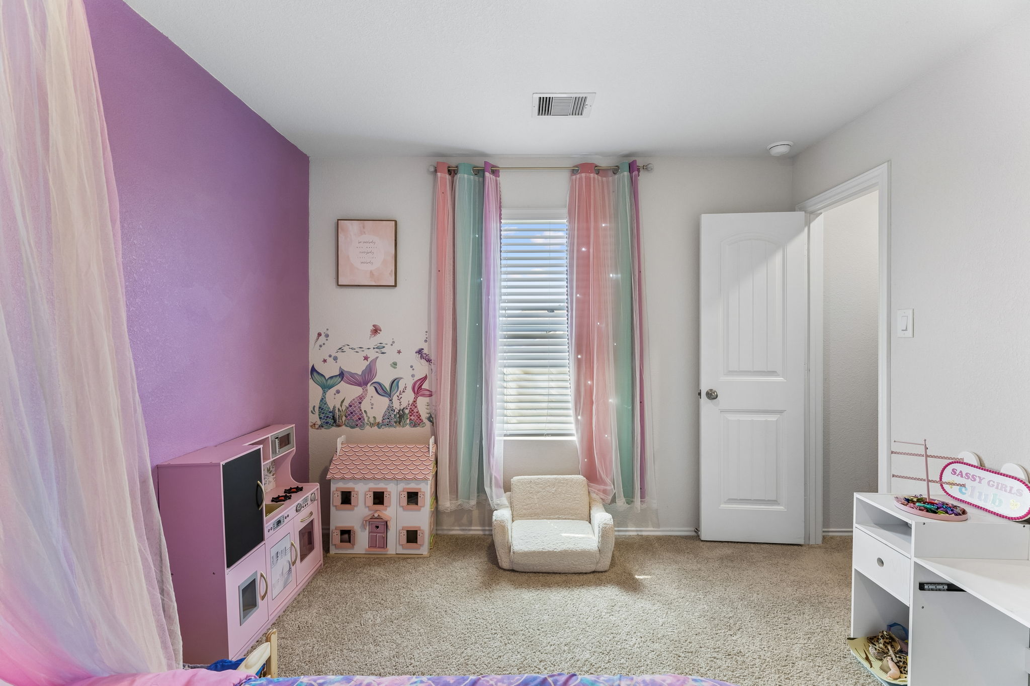 343 Sickle Loop Kyle, TX 78640 - Photo 32 of 40 Carpeted room featuring a single window with blinds, a white paneled door, and a textured accent wall