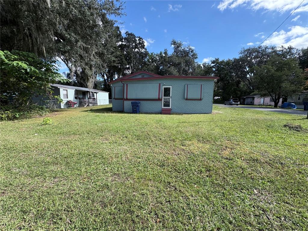 813 Northwest 5th Street Webster, FL 33597 - Photo 1 of 12 a house with trees in the background