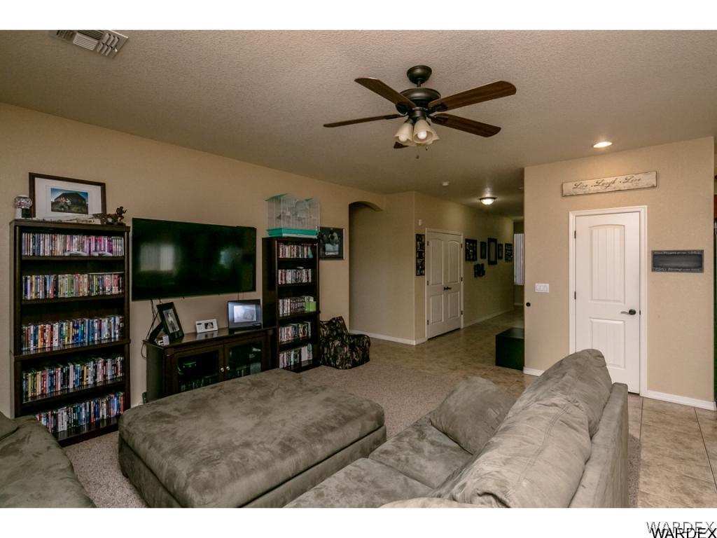 4909 North Neal Ranch Road Kingman, AZ 86401 - Photo 8 of 36 a living room with furniture and a flat screen tv