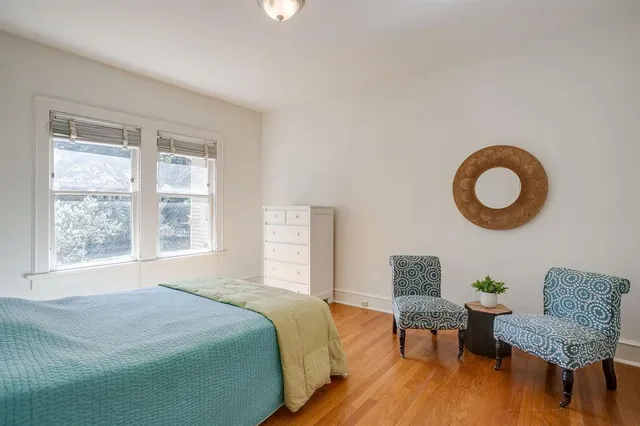 a bedroom with a bed and chair