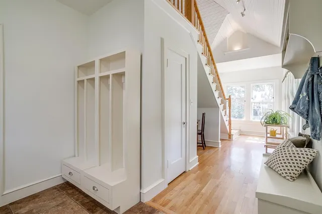 a view of entryway and hall with wooden floor