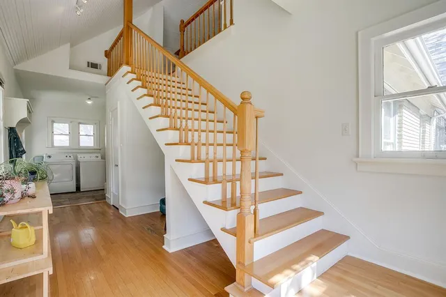 a view of entryway and hall with wooden floor