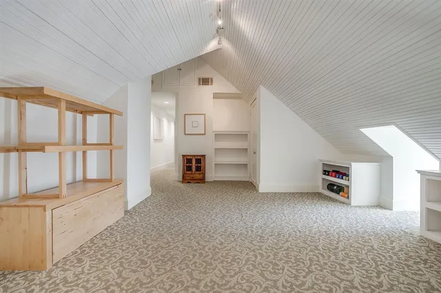 an empty room with furniture and windows