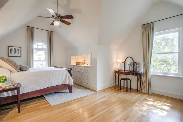 a spacious bedroom with a bed and a table