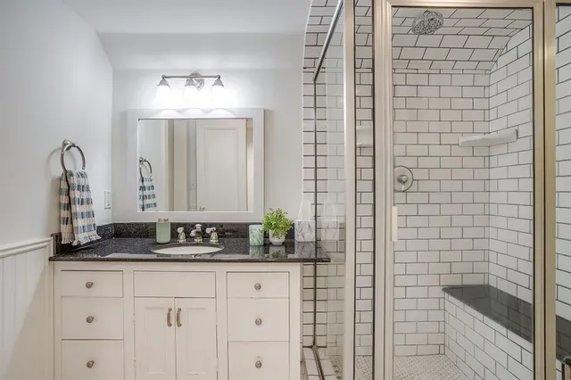 a bathroom with a double vanity sink and a mirror