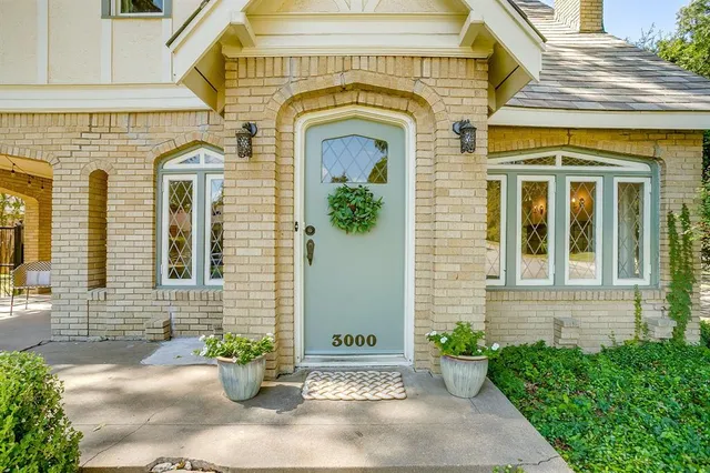 a front view of a house with potted plants