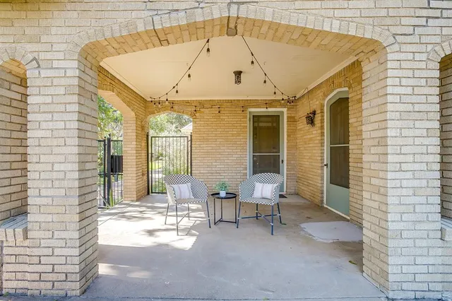 a view of a patio with table and chairs and potted plants