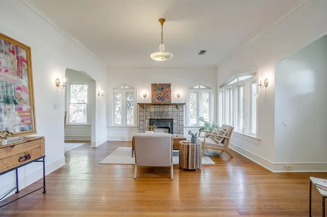 a living room with fireplace furniture and a wooden floor