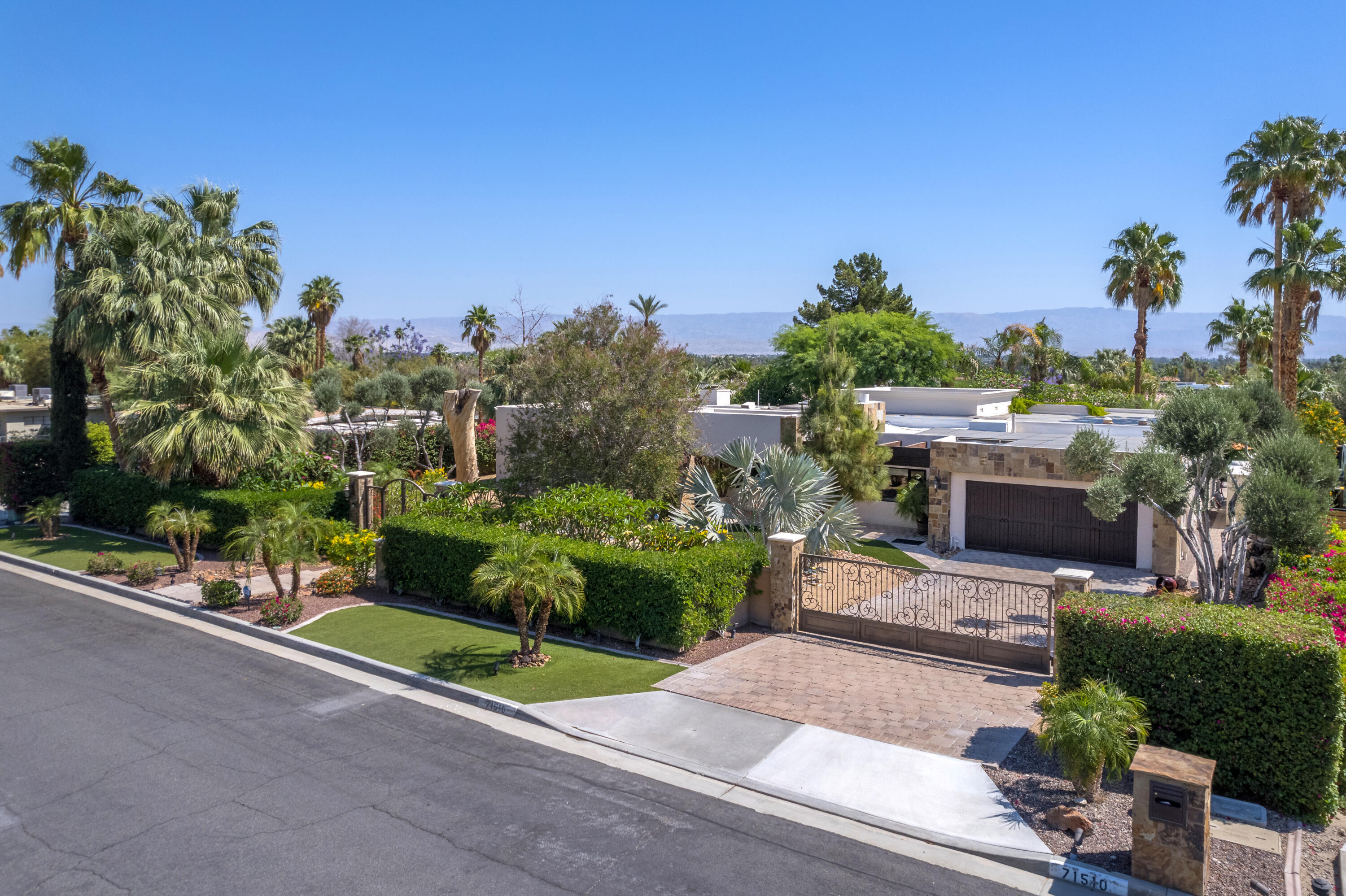 71510 San Gorgonio Road Rancho Mirage, CA 92270 - Photo 12 of 74 a view of a patio with potted plants and a large tree