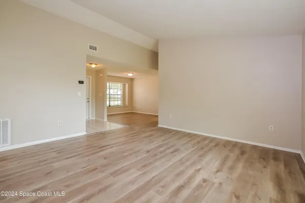 wooden floor in an empty room with a window