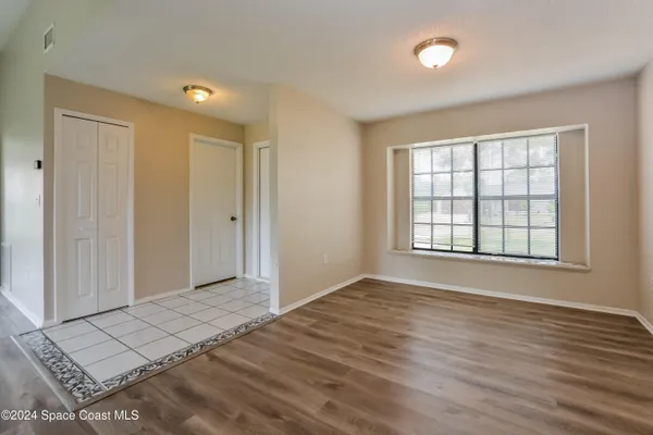 wooden floor in an empty room with a window