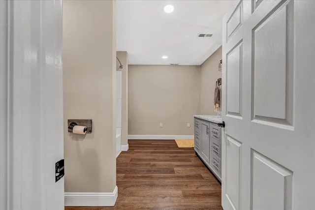 a view of a hallway with wooden floor and staircase