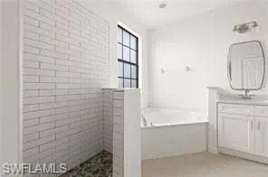 a bathroom with a sink a bathtub and a shower