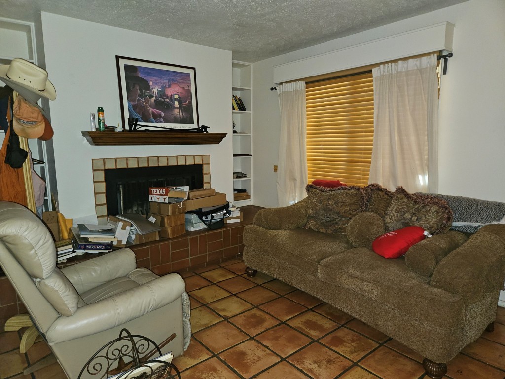 505 West 7th Street, Unit 108 Austin, TX 78701 - Photo 5 of 18 a living room with furniture or couch and a fireplace