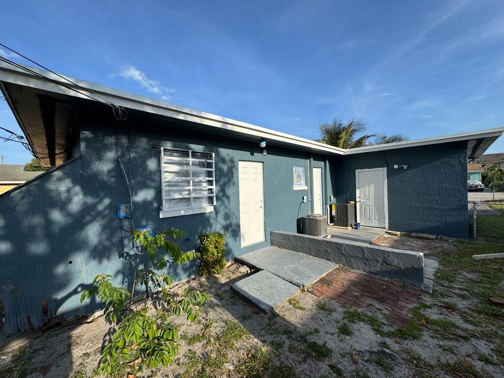 112 West 34th Street, Unit 1 Riviera Beach, FL 33404 - Photo 23 of 23 a front view of a house with garden