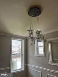 a chandelier fan and window