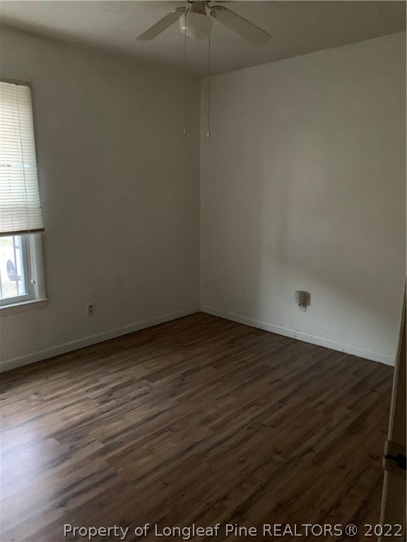 3309 Arrowhead Road Spring Lake, NC 28390 - Photo 8 of 10 an empty room with wooden floor and windows