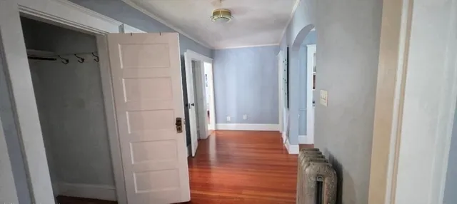 a view of a small space with wooden floor and a window