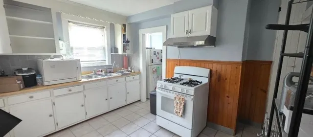a bathroom with a toilet a sink and a mirror