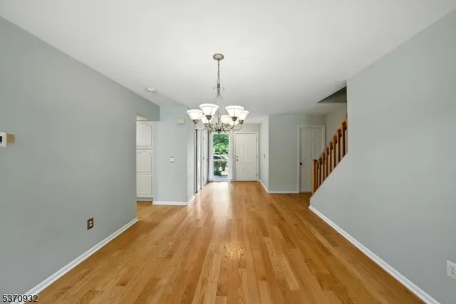 a view of livingroom with chandelier and wooden floor