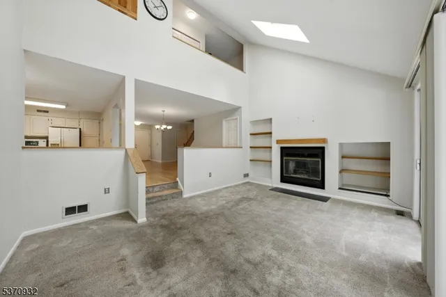 an empty room with a empty space and windows