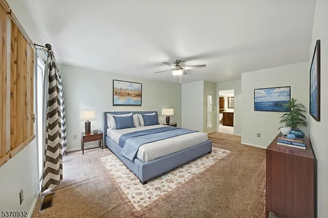 a view of an empty room with windows and entryway