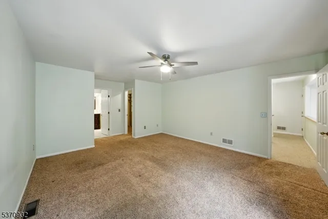 a spacious bathroom with a double vanity sink mirror and toilet