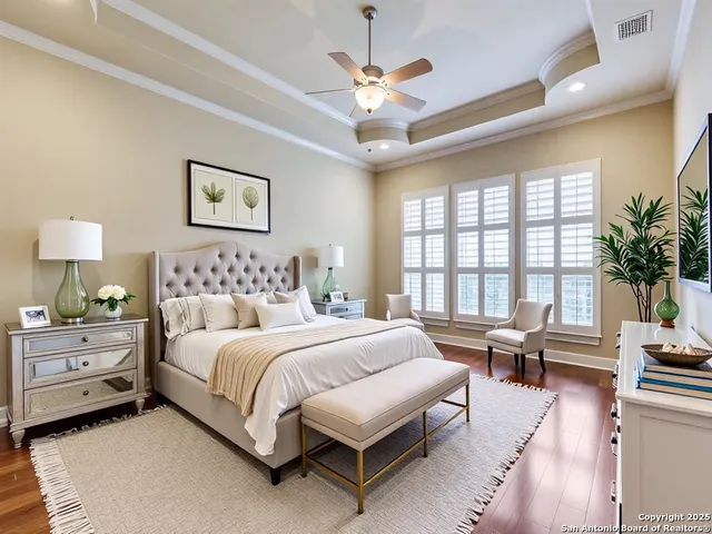a spacious bedroom with a large bed and a chandelier