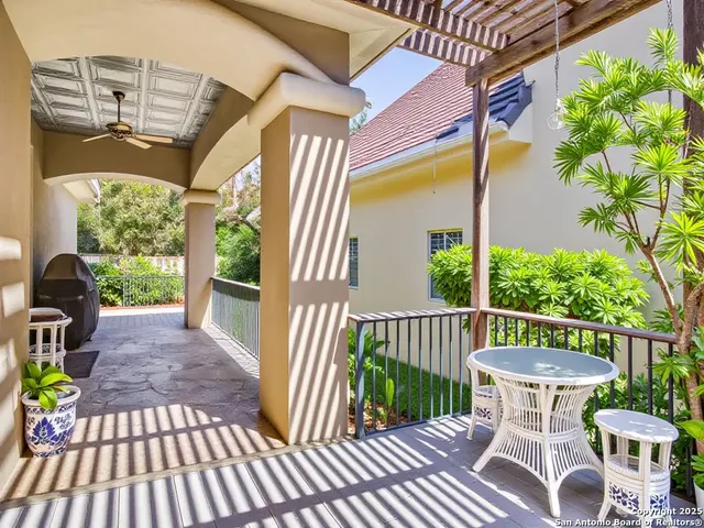 a view of a patio with table and chairs and potted plants