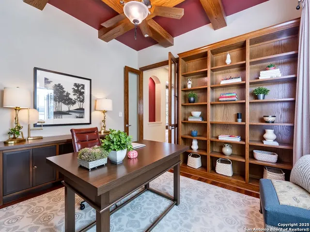 a living room with furniture a rug and a bookshelf