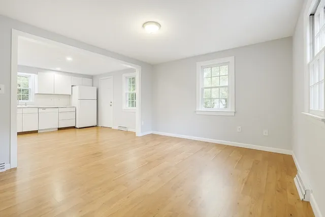 a view of a kitchen with white cabinets