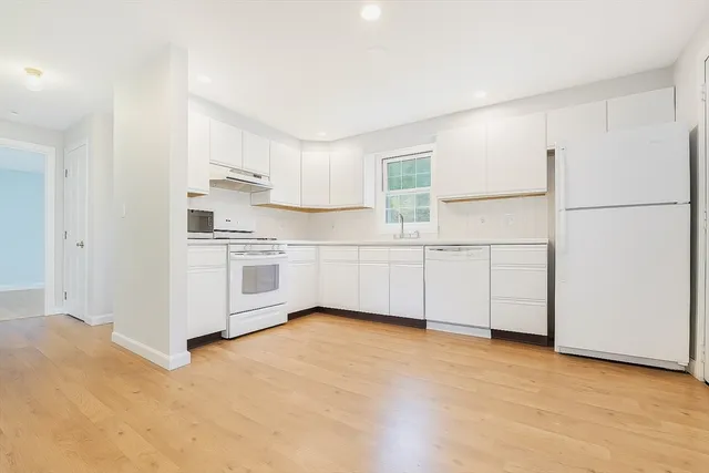a view of a kitchen with electric appliances