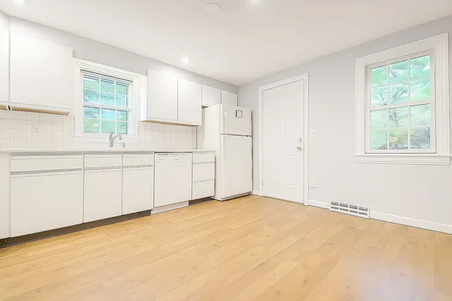 a view of a kitchen with a sink and a cabinets
