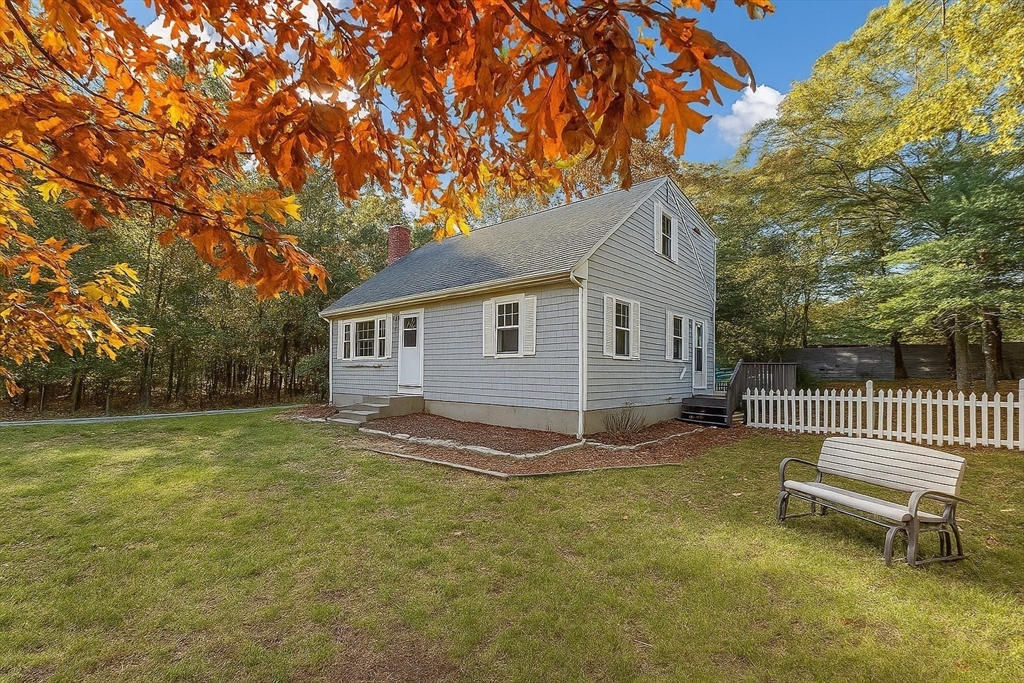 49 St Marks Road Falmouth, MA 02536 - Photo 3 of 38 a backyard of a house with table and chairs