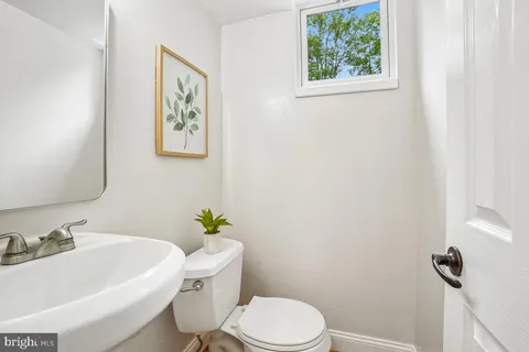 a white toilet sitting next to a bathroom sink
