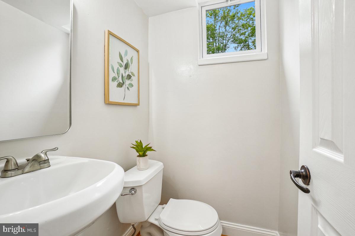827 Caddington Avenue Silver Spring, MD 20901 - Photo 36 of 45 a white toilet sitting next to a bathroom sink