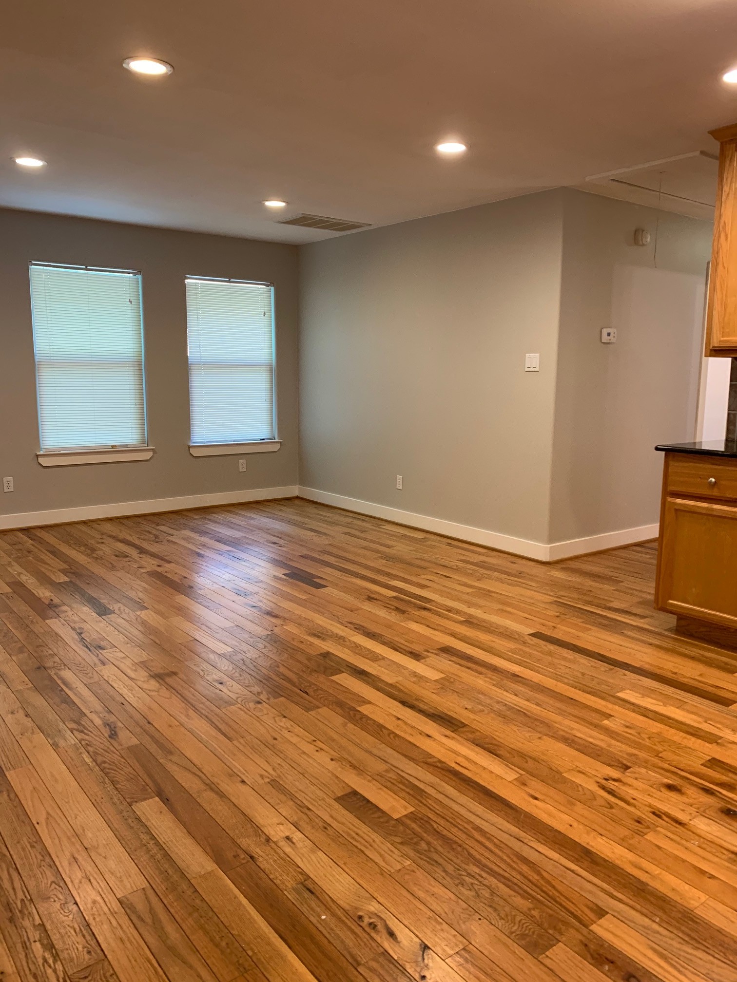 3207 Hampton Road, Unit B Austin, TX 78705 - Photo 3 of 7 an empty room with wooden floor and windows