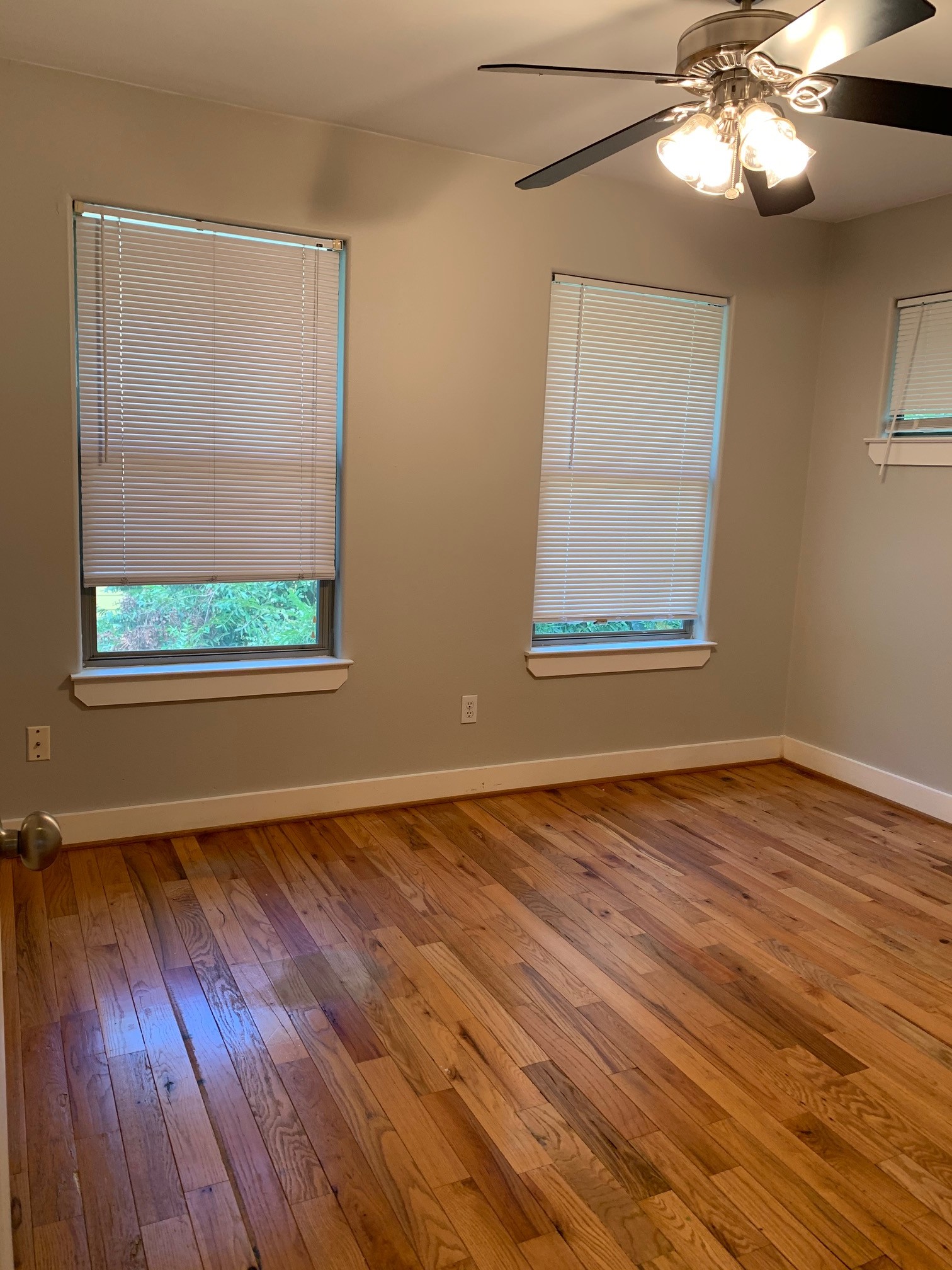 3207 Hampton Road, Unit B Austin, TX 78705 - Photo 5 of 7 a view of an empty room with wooden floor and a window